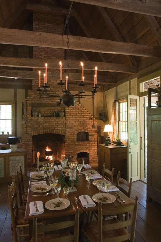 The new (but old-looking) addition houses the kitchen and dining areas, which feature a working fireplace, including a baking oven on the right, a crane holding a cookpot over the fire and a potager on the left.